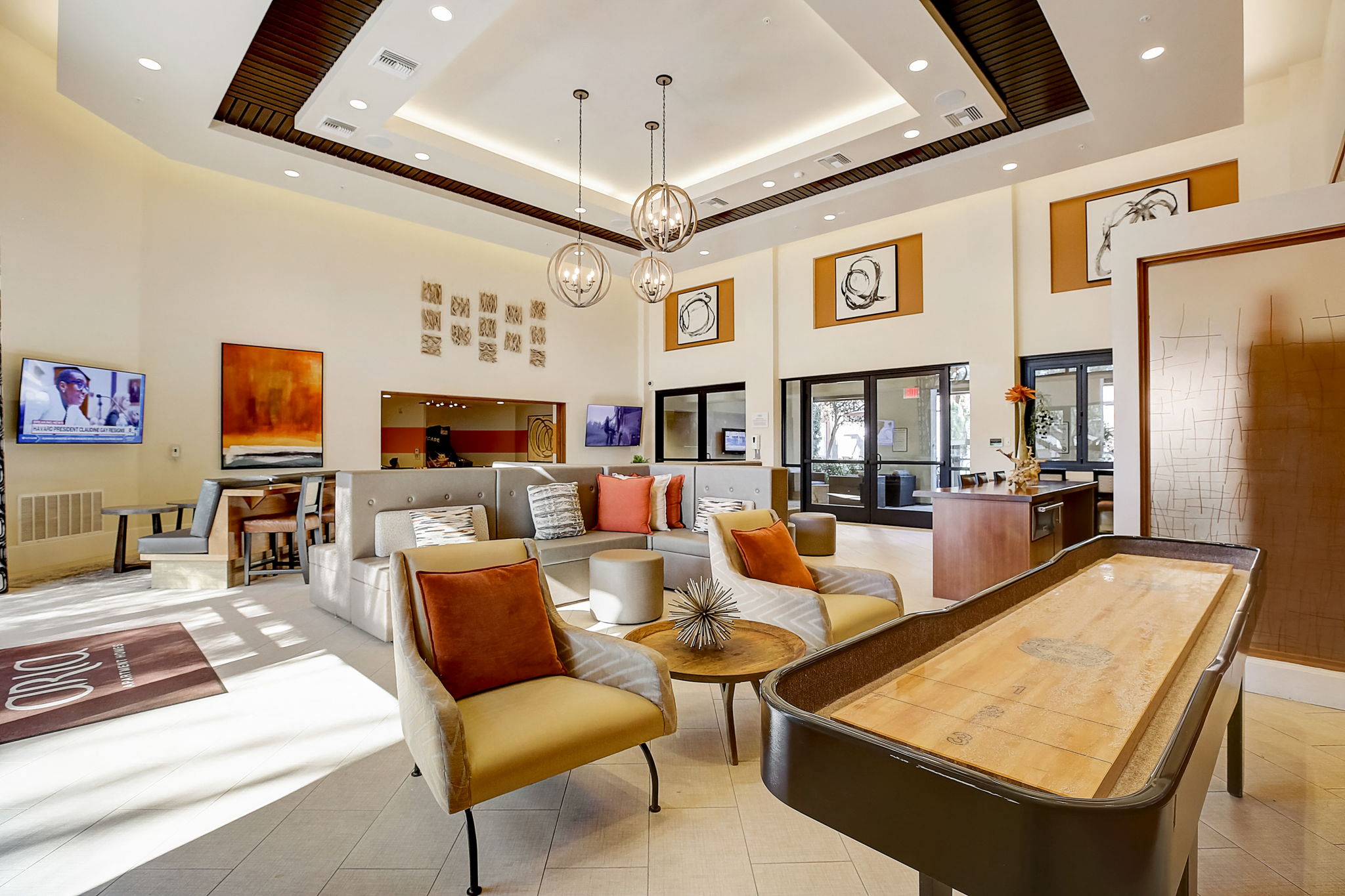 Clubhouse with cozy furniture and a table for social gatherings.,a living room with furniture and a table